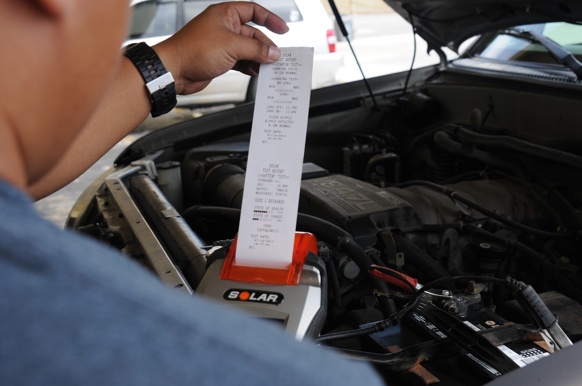 Josh Miranda, Army and Air Force Exchange Service Car Care Center parts specialist, conducts a seven-point charge test July 19, 2013 on Andersen Air Force Base, Guam. The test is used to determine a car batteries’ health and charging status. (U.S. Air force photo by Airman 1st Class Amanda Morris/Released)