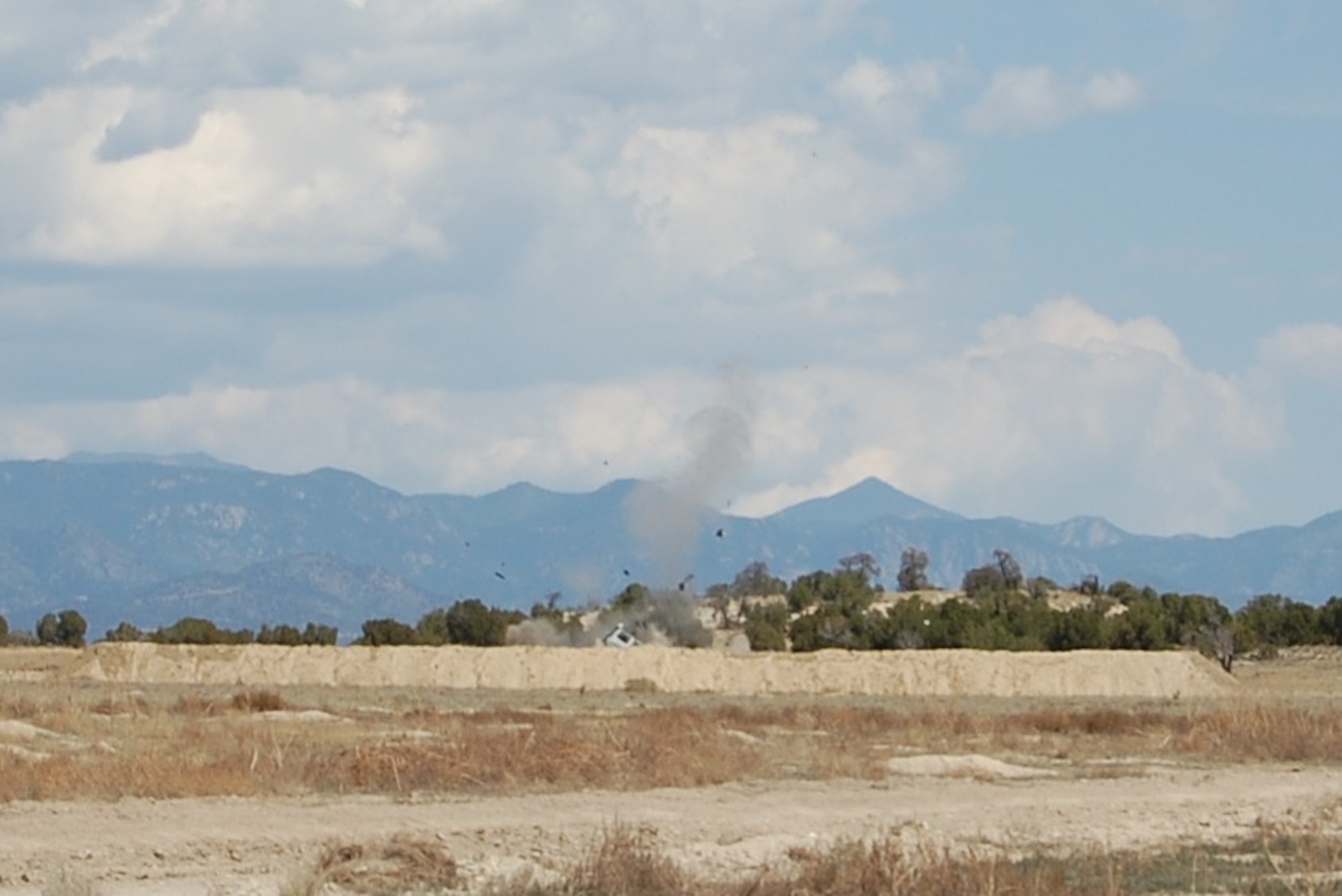 A hydraulic explosive device does massive damage to a vehicle during the EOD Demo Day July 12, 2013 at Airburst Range, Fort Carson, Colo. (U.S. Air National Guard photo by Capt. Kinder Blacke)