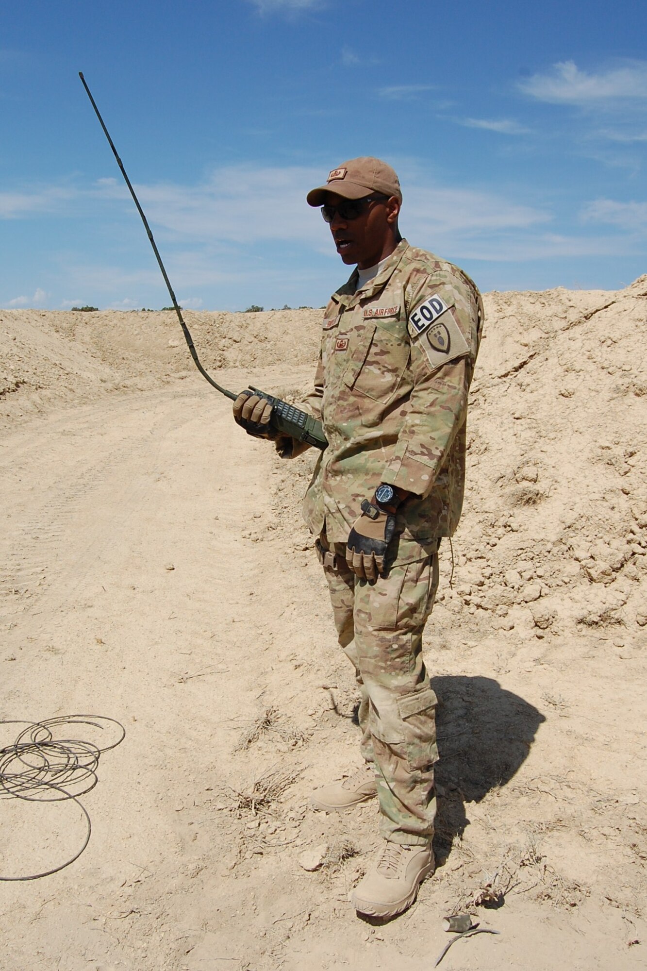 Staff Sgt. Christopher Broyles, 140th Explosive Ordnance Disposal Flight, sets up the remote firing device  for an explosive operation during the EOD Demo Day July 12, 2013 at Airburst Range, Fort Carson, Colo. (U.S. Air National Guard photo by Capt. Kinder Blacke)