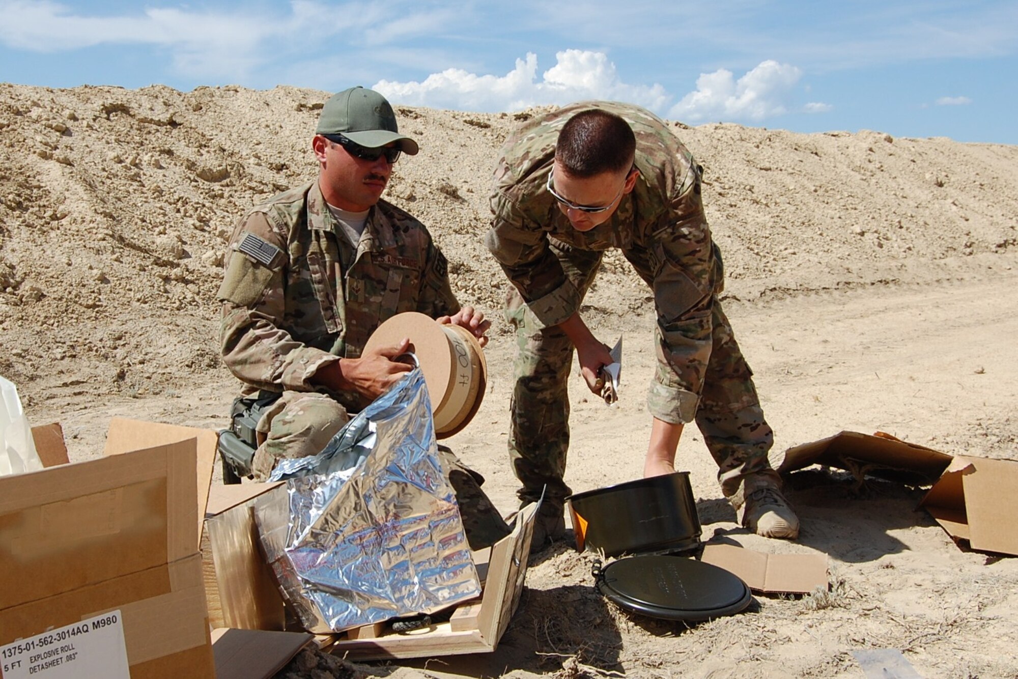 Colorado Air National Guard Airman 1st Class Darrell Linkus and Tech. Sgt. Andrew LeBeau, 140th Explosive Ordnance Disposal Flight,  construct explosive charges during the EOD Demo Day July 12, 2013 at Airburst Range, Fort Carson, Colo. (U.S. Air National Guard photo by Capt. Kinder Blacke)