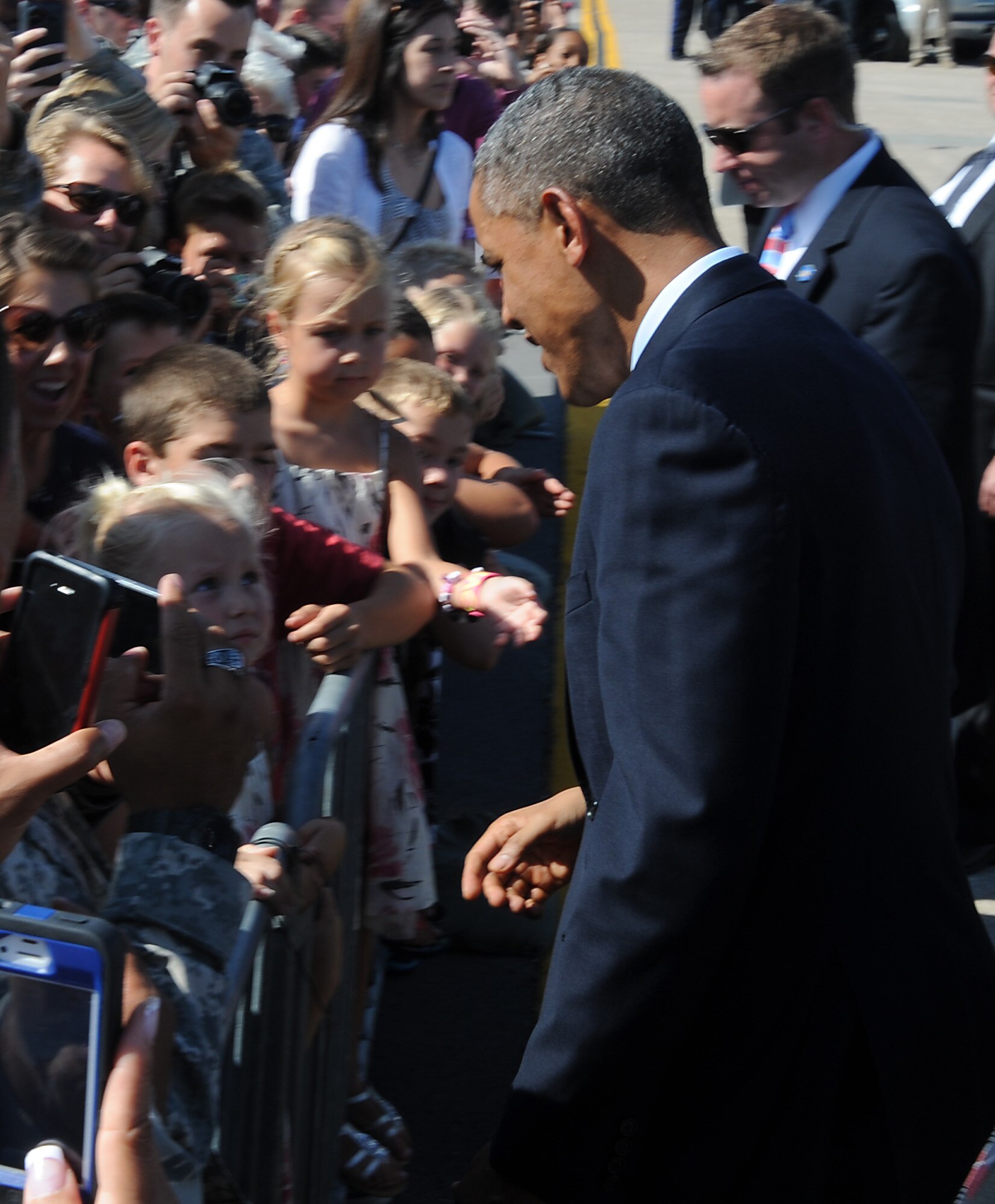 President Barack Obama is welcomed by a child after landing at Whiteman Air Force Base, Mo., July 24, 2013. The president landed at Whiteman en route to Warrensburg, Mo., for an official speech. (U.S. Air Force photo Airman 1st Class Bryan Crane/Released)