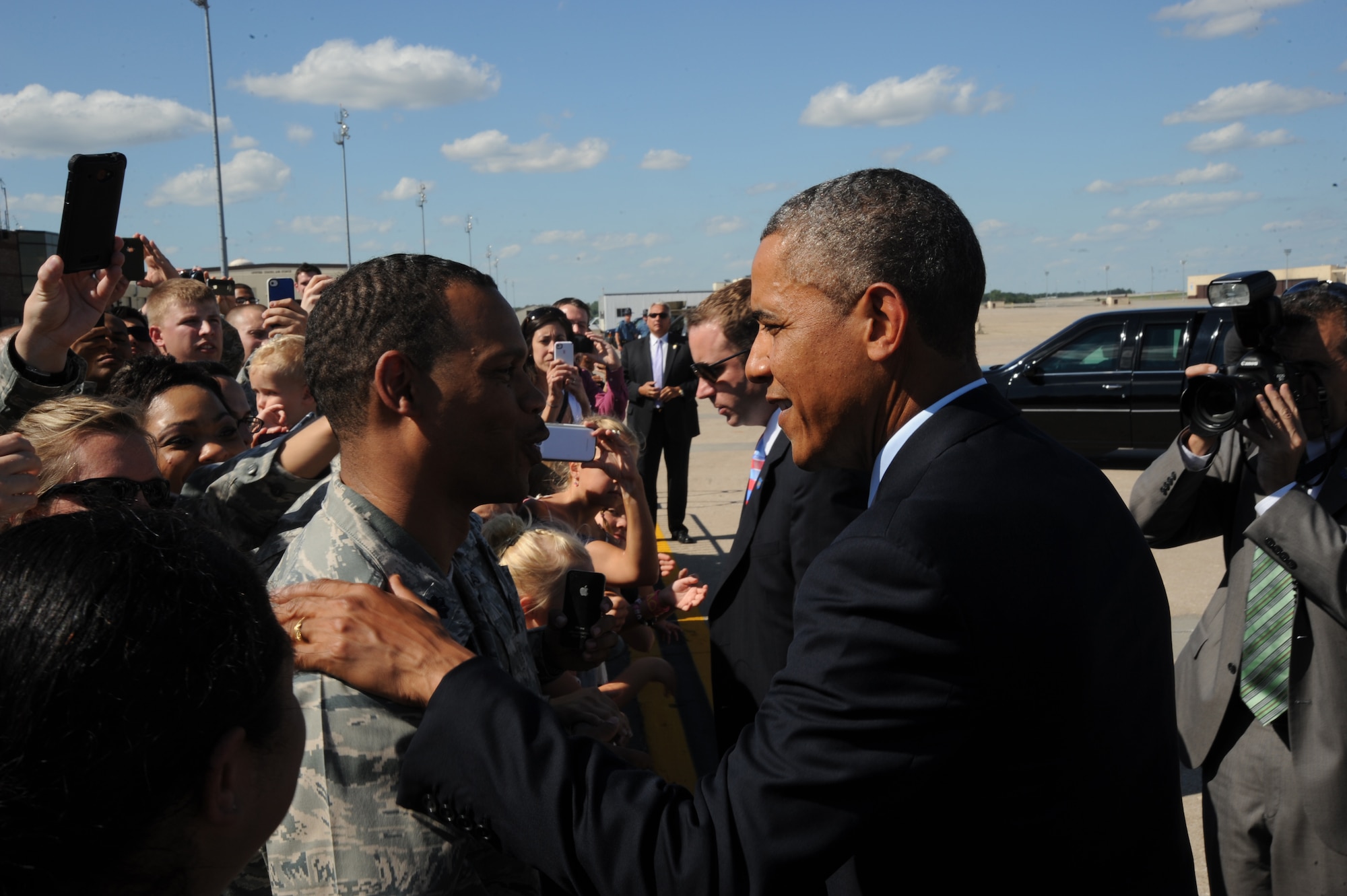 President Barack Obama shakes hands with Lt. Col. Kenneth Perry, 509th Medical Support Squadron commander, after landing at Whiteman Air Force Base, Mo., July 24, 2013. The president landed at Whiteman en route to Warrensburg, Mo., for an official speech. (U.S. Air Force photo Airman 1st Class Bryan Crane/Released)
