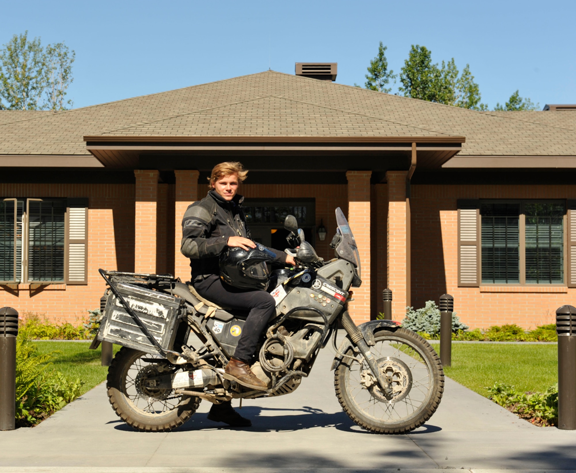 JOINT BASE ELMENDORF-RICHARDSON, Alaska--Oliver Plunket, 18-year-old native of the United Kingdom, stops at the Fisher House of Alaska on Joint Base Elmendorf-Richardson July 22. Plunket took a gap year between high school and college to travel as a way to raise money for the newly built Fisher House in the UK. His goal was to raise $150,000 but at the end of his travel he raised $89,000, which will all go to the newly built Fisher House. He rode his motorcycle from Argentina to Prudhoe Bay, Alaska, stopping to volunteer at other Fisher Houses and visiting various historic sites. (U.S. Air Force photo/Airman 1st Class Tammie Ramsouer)