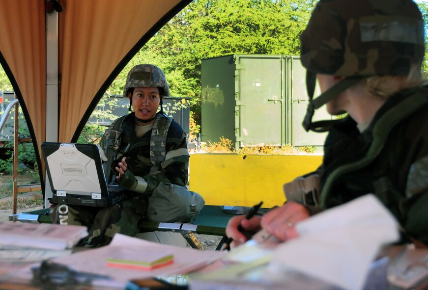 Master Sgt. Terilynn  Madrona, 154th Force Support Squadron, discusses equipment requirements for an after-action report at “Base X” on the last day of an Operational Readiness Exercise at Joint Base Pearl Harbor-Hickam, Hawaii, July 19, 2013. The week-long exercise demonstrated the effective use of Total Force Integration with active duty and Hawaii Air National Guard Airmen working side-by-side to accomplish the mission. (U.S.  Air Force photo/Tech. Sgt.  Michelle Thomas)  