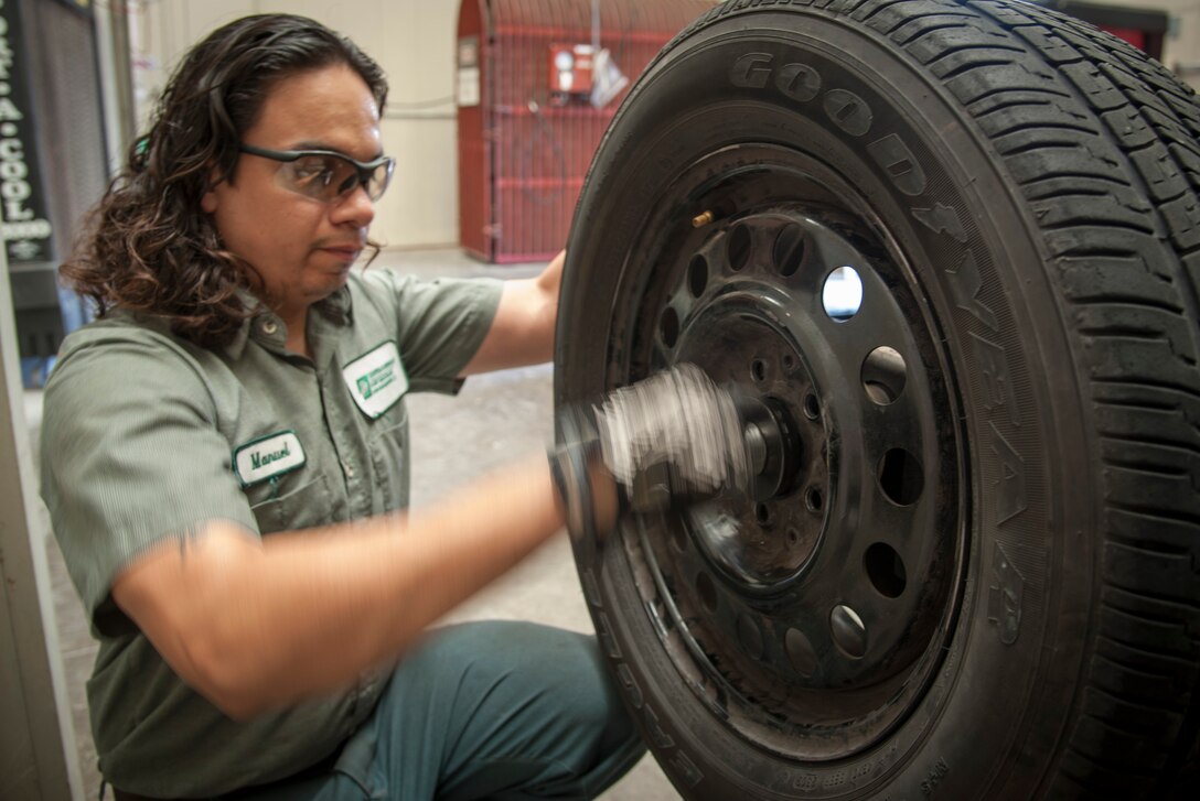 Manuel Rodriguez, 47th Logistics Readiness Division automotive technician, services a tire at Laughlin Air Force Base, Texas, July 23, 2013. The vehicle maintenance technicians perform brake repairs, electrical work for hydraulic repairs, auto body repairs and more. (U.S. Air Force photo/Senior Airman John D. Partlow)