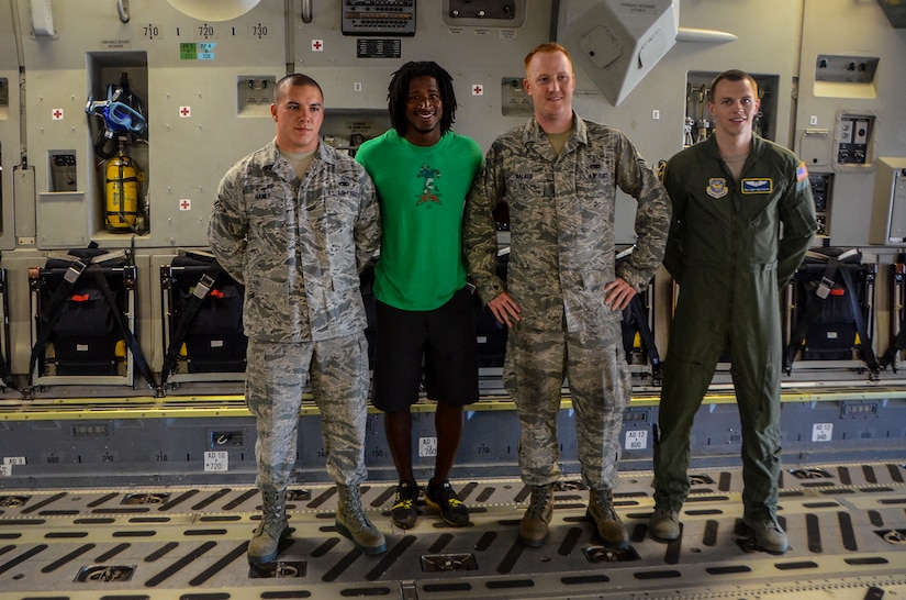 (Left to right) Senior Airman Johnathon Haney, 437th Aircraft Maintenance Squadron crew chief, Andre Roberts, Arizona Cardinals wide receiver, Senior Airman Kevin Walker, 437th AMXS crew chief, and Senior Airman Corey Brashear, 14th Airlift Squadron loadmaster, pose for a photo aboard a C-17 Globemaster III July 16, 2013, at Joint Base Charleston – Air Base. Roberts was visiting Charleston to host the Andre Roberts ProCamp July 15 and16 at the JB Charleston – Weapons Station, S.C. More than 100 base children attended the camp and participated in fundamental football drills. Small groups ensured each camper received maximum instruction from the area’s top football coaches. Roberts funded the camp, enabling children to attend for free.  (U.S. Air Force photo/ Senior Airman Jared Trimarchi)