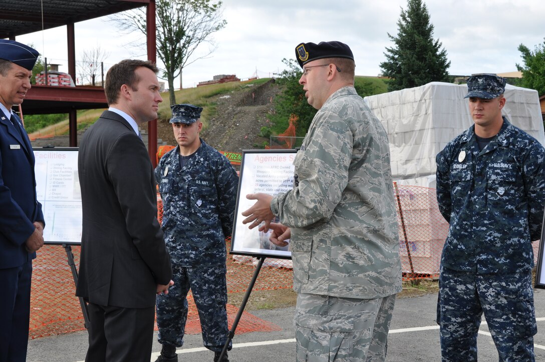 PITTSBURGH IAP ARS - Capt. Randall P. Gernhardt, 911th Airlift Wing Security Forces Squadron commander, briefs the Acting Secretary of the Air Force Eric Fanning, on the joint partnership between the Air Force Reserve and Navy Reserve while standing in front of the new site of the Navy Operational Support Center-Pittsburgh, July 24, 2013, at the Pittsburgh International Airport Air Reserve Station. The new NOSC site was one of several places the Acting Secretary stopped by during his two-hour visit here.  His time at the 911th was spent learning about the unit's mission and speaking with Airmen at their various workcenters. Acting Secretary Fanning's visit concluded with an "All Call" where he briefed personnel on the current state of the Air Force. He addressed total force initiatives, budgetary uncertainties, and sexual assault prevention. (U.S. Air Force photo by Ms. Emily Farrah)