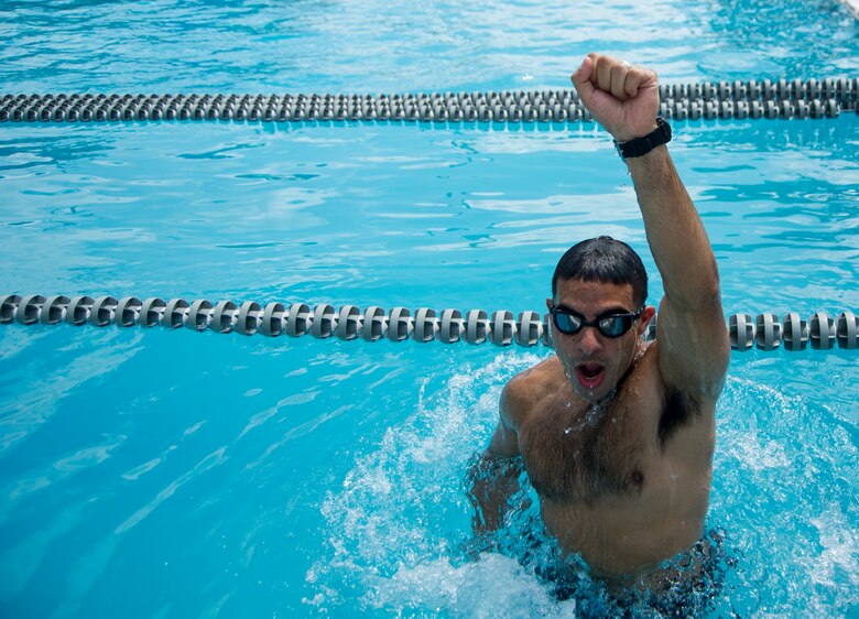 Senior Airman Jared Trimarchi, 628th Air Base Wing Public Affairs photo-journalist, surfaces at the Joint Base Charleston – Air Base pool. Trimarchi weighed more than 250 pounds when he began his road to fitness, and today has lost 62 pounds and continues to work out, eat healthy and help others reach their goals. (U.S. Air Force photo/ Senior Airman Melissa Goslin)