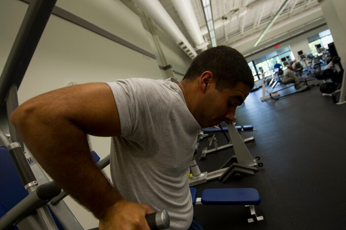 Senior Airman Jared Trimarchi, 628th Air Base Wing Public Affairs photo-journalist, completes a set of dips, an exercise that targets the triceps, at the Joint Base Charleston – Air Base, S.C. Trimarchi weighed more than 250 pounds when he began his road to fitness, and today has lost 62 pounds and continues to work out, eat healthy and help others reach their goals. (U.S. Air Force photo/ Senior Airman Melissa Goslin)