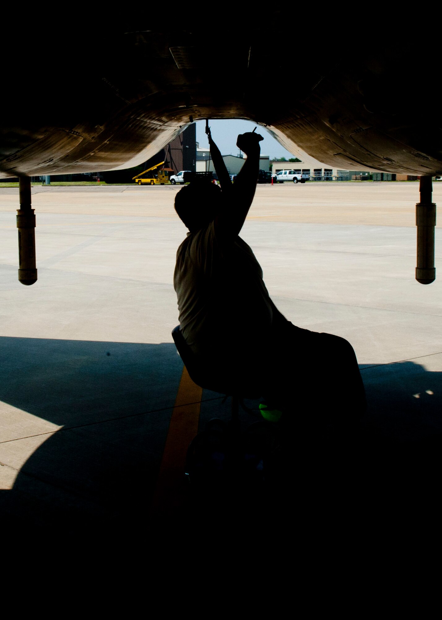 U.S. Air Force Senior Airman Charles Loeffler,  125th Fighter Wing crew chief, retrieves an oil sample for testing from an F-15 Eagle during the Trident Warrior exercise at Langley Air Force Base, Va., July 18, 2013. The Joint Tactical Information Distribution System will allow fourth and fifth-generation fighters to pass information freely for the first time. (U.S. Air Force photo by Staff Sgt. John D. Strong II / Released)