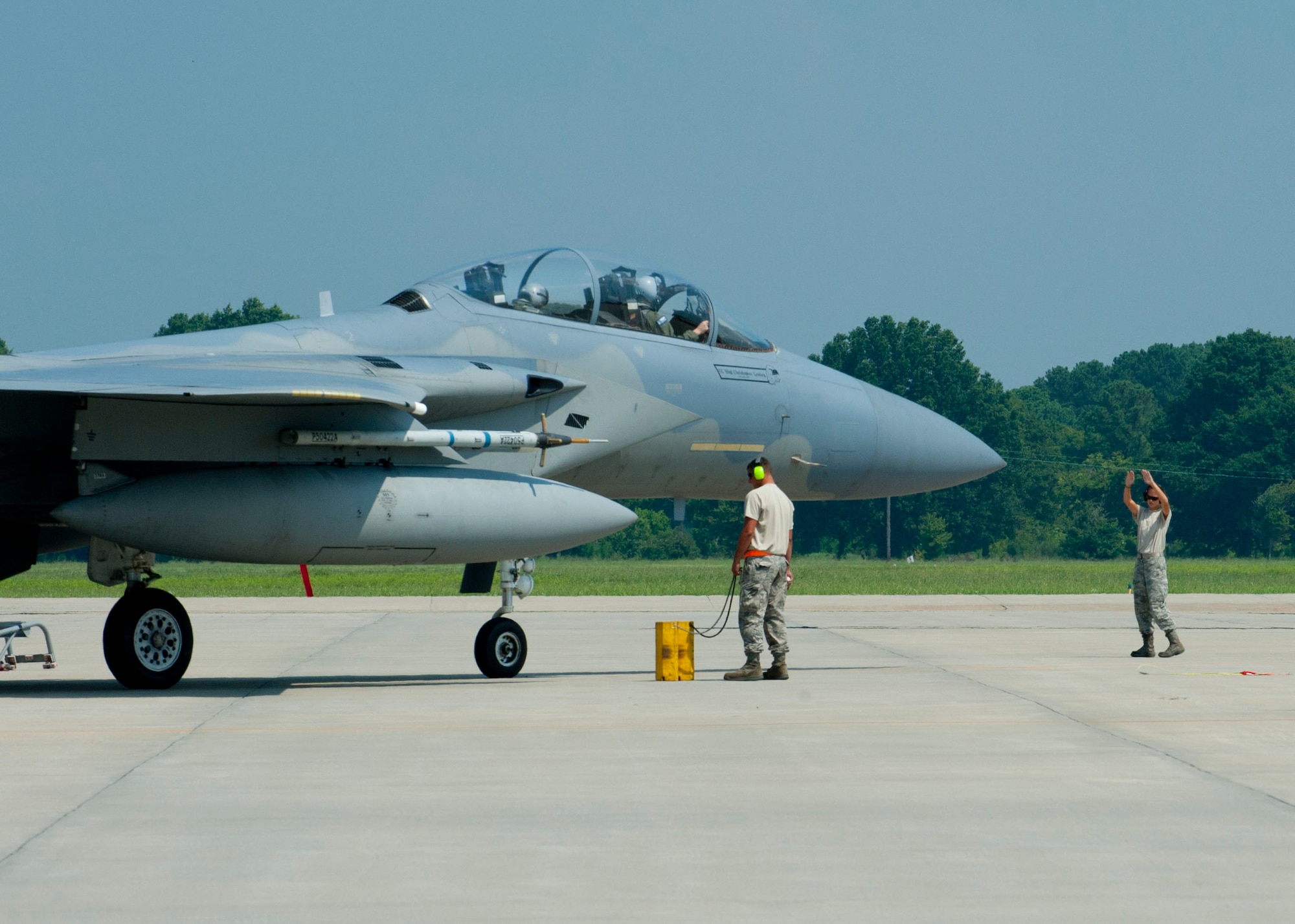 U.S. Air Force crew chiefs from the 125th Fighter Wing, guide an F-15 Eagle during the Trident Warrior exercise at Langley Air Force Base, Va., July 18, 2013. The exercise tested fourth and fifth-generation fighter integration using an experimental Joint Tactical Information Distribution System, while simulating aerial combat. (U.S. Air Force photo by Staff Sgt. John D. Strong II / Released)