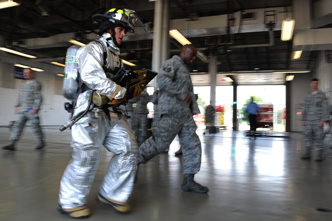 U.S. Air Force Chief Master Sgt. Richard Parsons, command chief of Air Combat Command, finishes the firefighters’ challenge at the 633rd Civil Engineer Squadron fire station on Langley Air Force Base, Va., July 17, 2013. Firefighters at the 633rd CES must finish the physical assessment in less than eight minutes in order to pass. (U.S. Air Force photo by Airman 1st Class Victoria H. Taylor/Released)