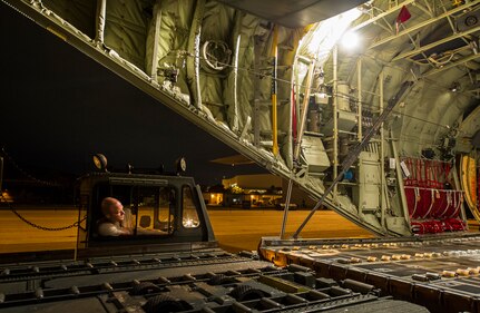 Staff Sgt. Kenneth Hulsey, 437th Aerial Port Squadron ramp service supervisor, operates a K-loader during an early morning cargo load July 23, 2013, at Joint Base Charleston - Air Base, S.C. The C-130J-30 was loaded with rations and supplies bound for Bogota. The C-130J-30 is a stretch version of the C-130J, a proven, highly reliable and affordable airlifter. The C-130J-30 adds 15 feet to the fuselage, increasing usable space in the cargo compartment. (U.S. Air Force photo/ Senior Airman George Goslin)