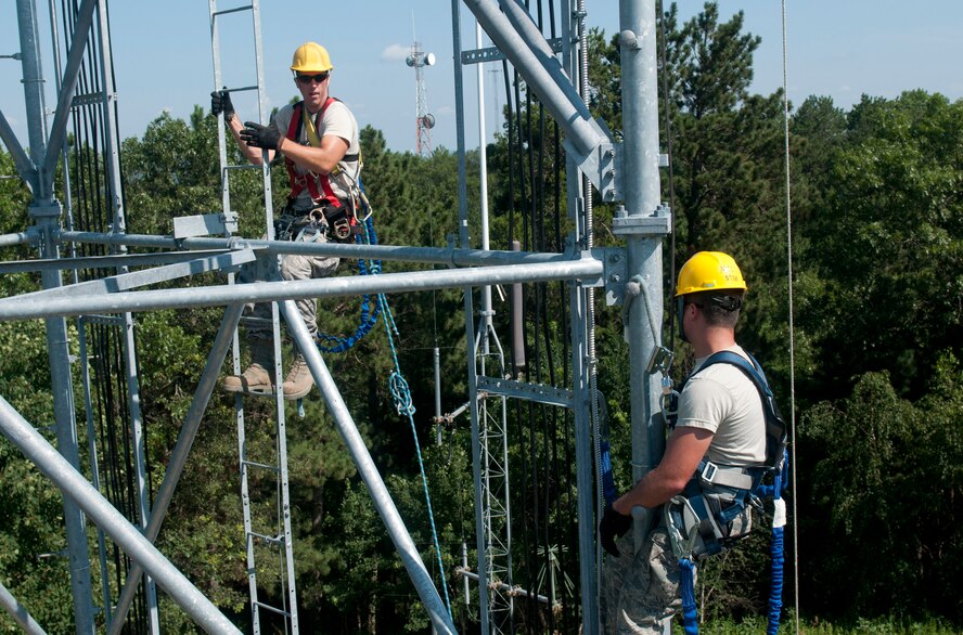 U.S. Air Force Staff Sgt. Robert Farrington, left, scales a ladder to rescue airman 1st Class Matthew Molus, who is playing the role of an unresponsive victim, during a tower rescue exercise at Volk Field in Camp Douglas, Wis., July 18, 2013. Patriot Exercise is a domestic operations scenario to assess the National Guard's ability to assist state and local agencies in response to multiple emergencies. More than 1,100 U.S. Service members and civil authorities, to include the FBI, Department of Health and Human Services and a variety of state agencies, were to participate in the exercise. (U.S. Army National Guard photo by Staff Sgt. Megan Burnham/Released)