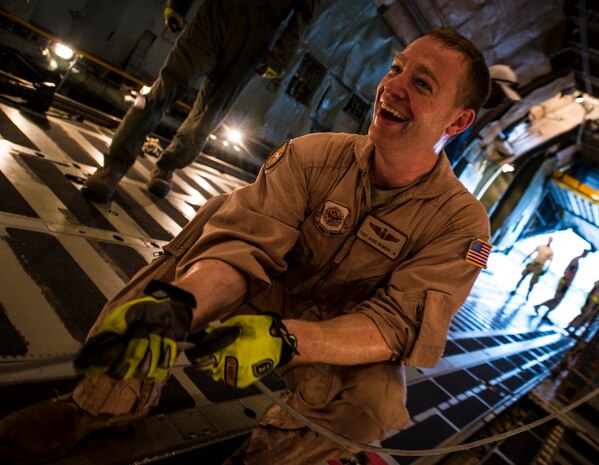 Tech. Sgt. David Bowers, West Virginia Air National Guard member, 167th Maintenance Squadron C-5 Galaxy load master from Martinsburg, W. Va., feeds a metal tension cord into place before using it to move a load of cargo on a C-5 July 22, 2013, at Joint Base Charleston – Air Base, S.C. The cargo is being used to assist operation Enduring Freedom. The C-5 is one of the largest aircraft in the world and the largest airlifter in the Air Force inventory. (U.S. Air Force photo/ Senior Airman Dennis Sloan)