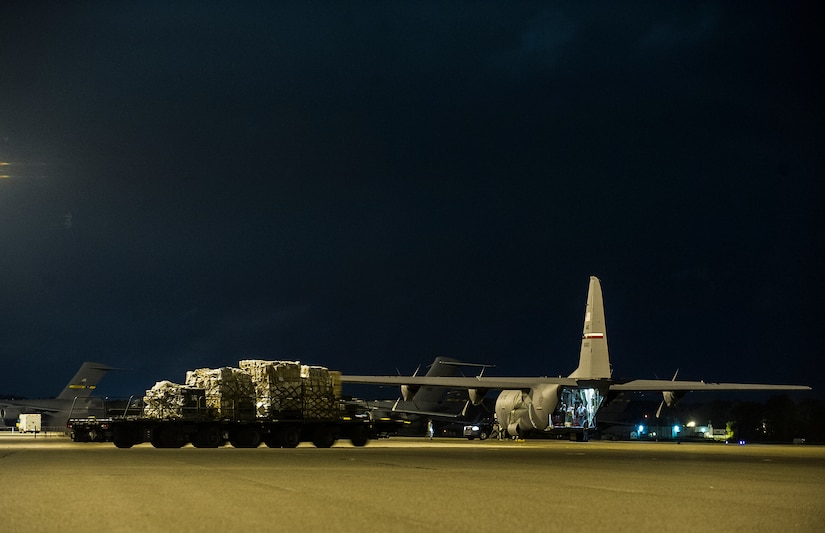 A C-130J-30 from the 317th Airlift Group, Dyess Air Force Base, Texas, waits to be loaded during an early morning cargo load July 23, 2013, at Joint Base Charleston - Air Base, S.C. The C-130J-30 was loaded with rations and  supplies bound for Bogota. The C-130J-30 is a stretch version of the C-130J, a proven, highly reliable and affordable airlifter. The C-130J-30 adds 15 feet to the fuselage, increasing usable space in the cargo compartment. (U.S. Air Force photo/ Senior Airman George Goslin)