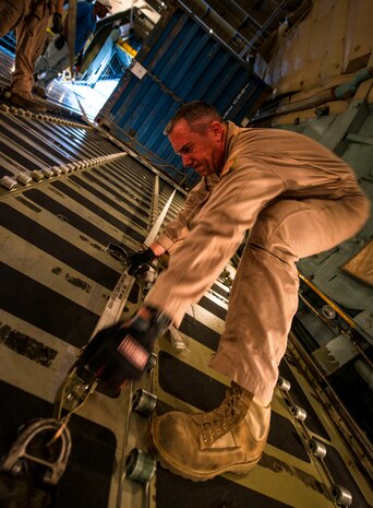 Master Sgt. David Martens, West Virginia Air National Guard member, 167th Maintenance Squadron C-5 Galaxy load master from Martinsburg, W. Va., straps down cargo on a C-5 July 22, 2013, at Joint Base Charleston – Air Base, S.C. The cargo is being used to assist operation Enduring Freedom. The C-5 is one of the largest aircraft in the world and the largest airlifter in the Air Force inventory. (U.S. Air Force photo/ Senior Airman Dennis Sloan)