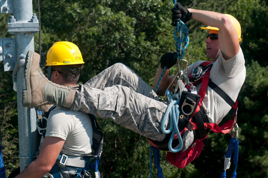 U.S. Air Force Staff Sgt. Robert Farrington, right, works to rescue Airman 1st Class Matthew Molus, who is playing the role of an unresponsive victim, during a tower rescue exercise at Volk Field in Camp Douglas, Wis., July 18, 2013. Patriot Exercise is a domestic operations scenario to assess the National Guard's ability to assist state and local agencies in response to multiple emergencies. More than 1,100 U.S. Service members and civil authorities, to include the FBI, Department of Health and Human Services and a variety of state agencies, were to participate in the exercise.(U.S. Army National Guard photo by Staff Sgt. Megan Burnham/Released)