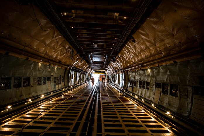 West Virginia Air National Guard Airmen from the 167th Airlift Wing, Martinsburg, W. Va., load cargo onto a C-5 Galaxy July 22, 2013, at Joint Base Charleston, S.C. The cargo is being used to assist operation Enduring Freedom. The C-5 is one of the largest aircraft in the world and the largest airlifter in the Air Force inventory. (U.S. Air Force photo/ Senior Airman Dennis Sloan)