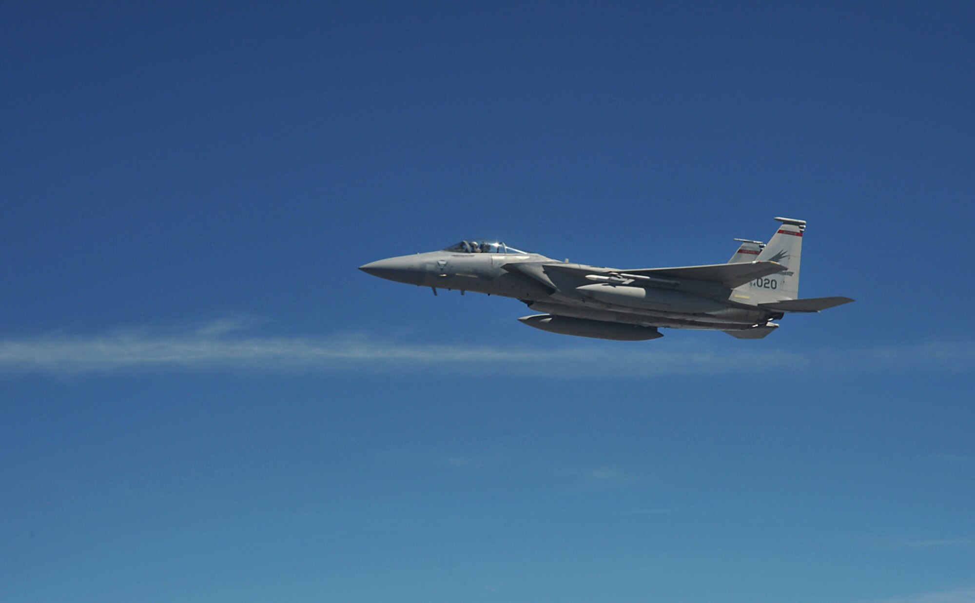 An F-15 Eagle, from the 142nd Fighter Wing, Oregon Air National Guard, Portland, Ore., flies over northeast Kansas after receiving fuel from a KC-135 Stratotanker assigned to McConnell Air Force Base, Kan., July 23, 2013. Eight F-15s received fuel from a three-ship tanker sortie during the mission. McConnell has 62 KC-135s, which provide global reach by conducting air refueling and airlift where and whenever needed. (U.S. Air Force photo/ Staff Sgt. Jess Lockoski)