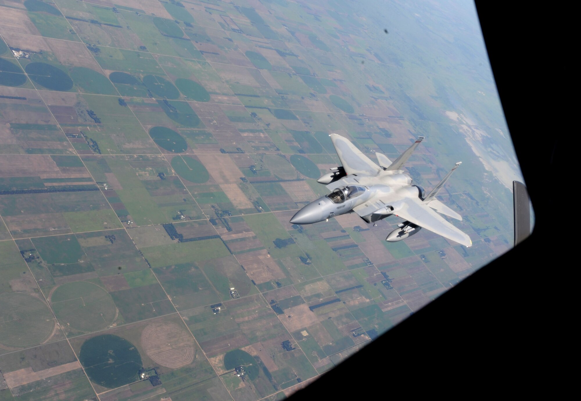 After receiving fuel from a KC-135 Stratotanker assigned to McConnell Air Force Base, Kan., an F-15 Eagle from the 142nd Fighter Wing, Oregon Air National Guard, Portland, Ore., maneuvers away from the boom over northeast Kansas July 23, 2013. Three Stratotankers refueled eight F-15s during the training mission. (U.S. Air Force photo/Senior Airman Laura L. Valentine)