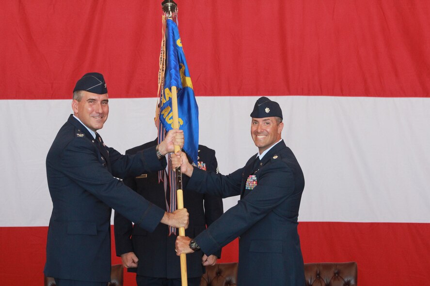 Col. John J. Cooper, Commander, 552nd Operations Group passes the guidon for the 960th Airborne Air Control Squadron to Lt. Col. Keven P. Coyle. Previously, Lt. Col. Coyle was the Director of Operations of the 968th Expeditionary Air Control Squadron, Al Dhafra AB, United Arab Emirates. Lt. Col. Coyle assumes command of the 960th from Lt. Col. Michael S. Smith who is heading to up to the 552nd Operations Group as Deputy Group Commander. (Air Force photo by Master Sgt. Joel D. Andren)