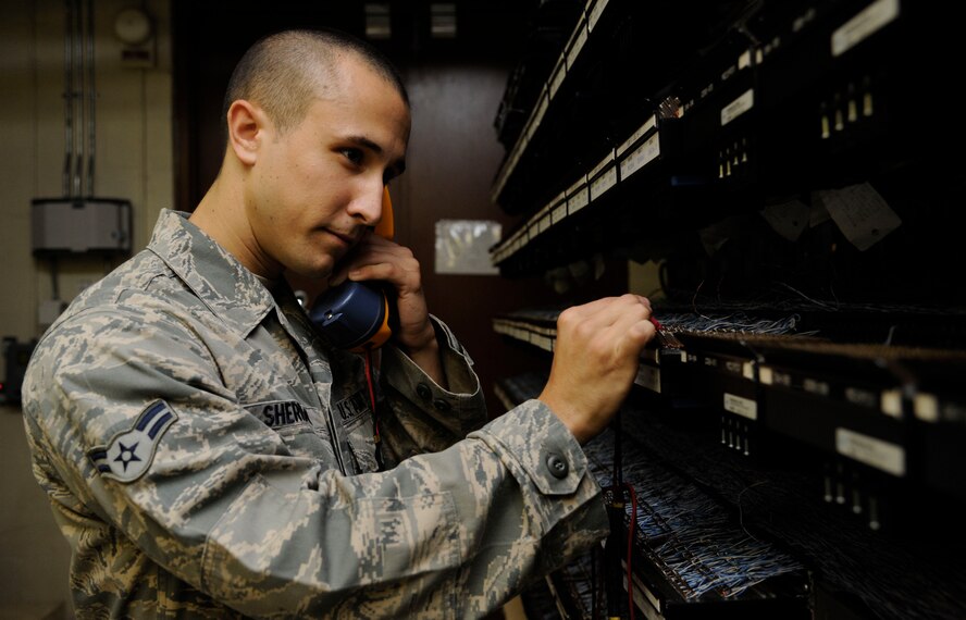 Airman 1st Class Zachary Sheridan, 2nd Communications Squadron cyber transport systems technician, uses a lineman's handset on Barksdale Air Force Base, La., July 23, 2013. Lineman's handsets are used to test the connection of a phone line during maintenance. (U.S. Air Force photo/Airman 1st Class Andrew Moua)