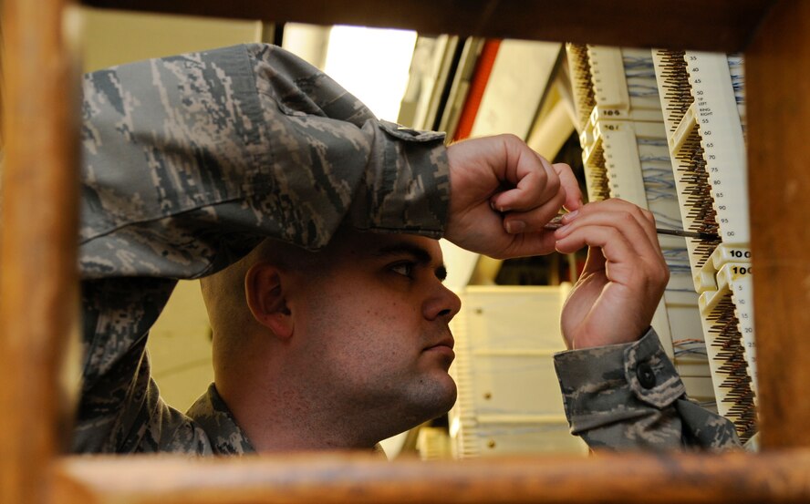 Senior Airman Jared Cooke, 2nd Communications Squadron cyber transport systems technician, wraps cable on Barksdale Air Force Base, La., July 23, 2013. Cyber transport Airmen are in charge of maintaining Barksdale's infrastructure ranging from telephone lines to computer networks. (U.S. Air Force photo/Airman 1st Class Andrew Moua)