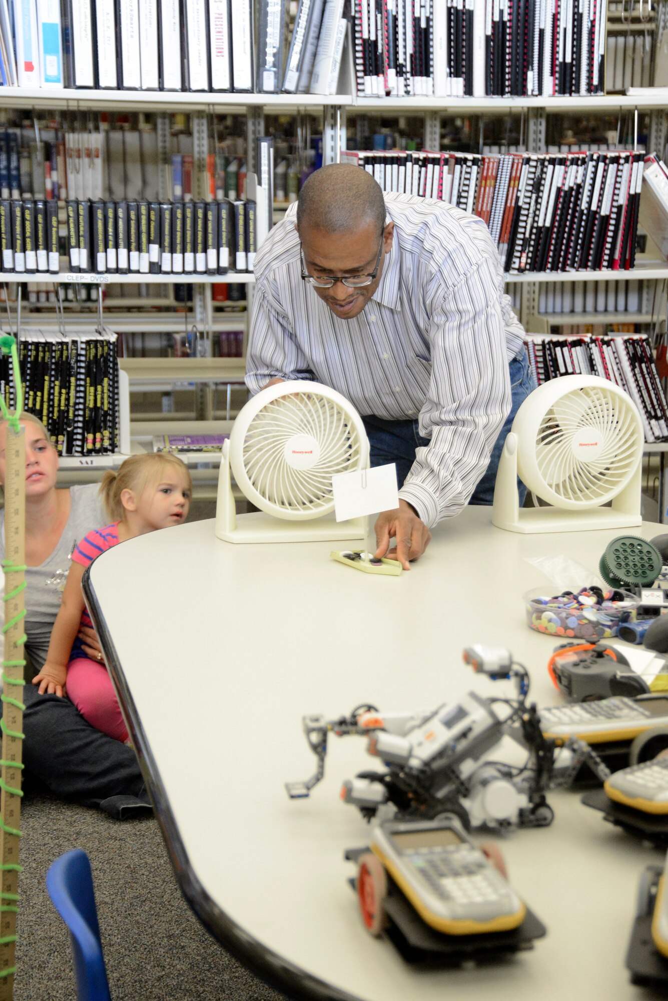 Mickey Bowen, 412th Test Wing STEM outreach director, uses a paper boat powered by a fan to demonstrate the concepts of force and weight. (U.S. Air Force photo by Rebecca Amber) 
