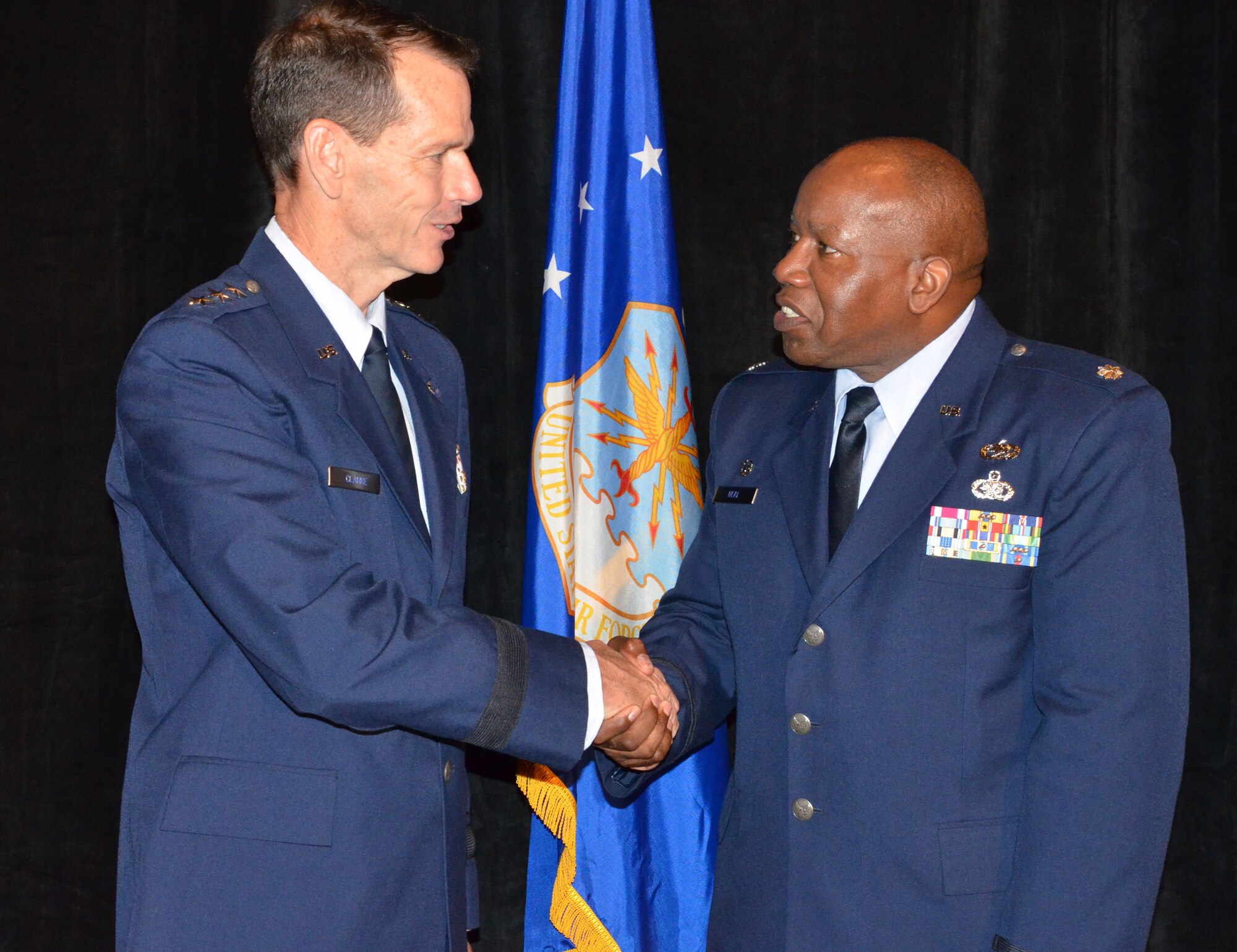 Director of the Air National Guard Lt. Gen. Stanley Clarke, left, congratulates Roy Wilkins Renowned Service Award recipient Lt. Col. Anderson Neal Jr., 188th Maintenance Group commander, during an Armed Services and Veterans Affairs Awards luncheon in Orlando, Fla., July 16, 2013. (Photo by Master Sgt. Thomas Kielbasa)