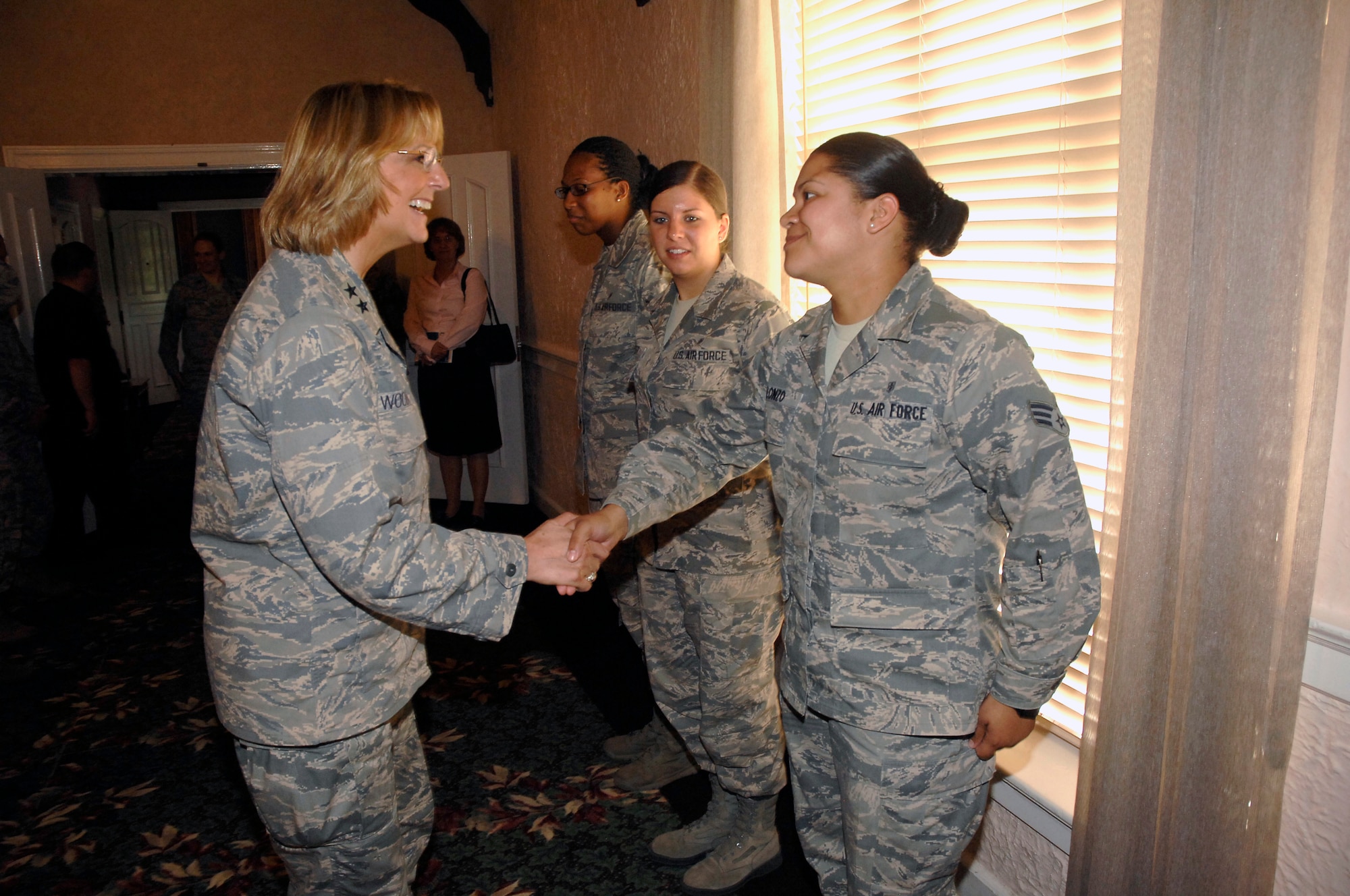 Maj. Gen. Margaret Woodward, left, greets Senior Airman Jhosselin Alonzo during a focus group session at Wright-Patterson Air Force Base, Ohio, July 23, 2013. Woodward and her team are undergoing a series of visits at several bases, to gather information and hear from Airman in the field about sexual assault prevention and reporting. During her visit, she met with several groups, to include officers, enlisted and DOD civilians. Woodward is the Air Force Sexual Assault Prevention and Response Office director  and Alonzo heads up Wright-Patt's Air Force Junior Support, a group founded on helping their peers cope with the many challenges young
Airmen face.  (U.S. Air Force photo/Albert Bright)