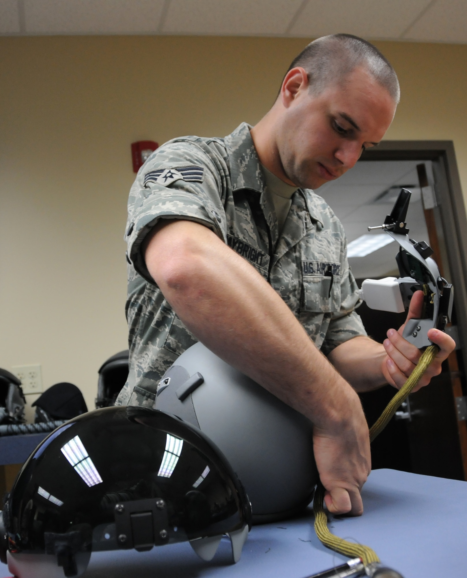 Senior Airman Robert Waybright, 482nd Operations Support Squadron life support, assembles the Helmet Mounted Integrated Targeting unit on a pilot’s helmet at Homestead Air Reserve Base, Fla., July 17. HMIT, currently being fielded at Homestead ARB, is an avionics system that gives the pilot the ability to cue a weapon against a target simply by looking at it anywhere in the cockpit. (U.S. Air Force photo/Ross Tweten)