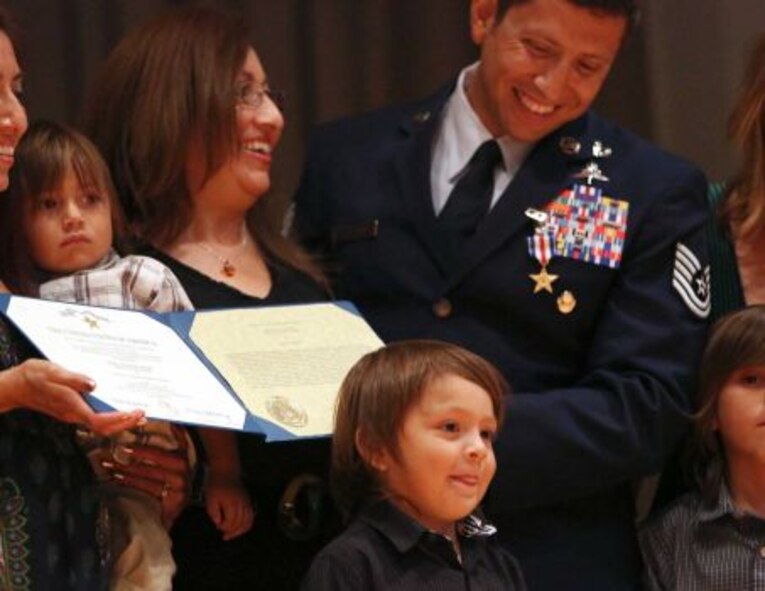 Tech Sgt. Ismael Villegas with the 24th Special Operations Wing, laughs as his nephew Izzy Rivas jokes for the cameras after Villegas was awarded a Silver Star during a ceremony at Joint Base San Antonio-Lackland on Monday July 22, 2013. Air Force Special Operations Command Lt. General Eric Fiel presented the commendations. (Photo By Helen L. Montoya/San Antonio Express-News)