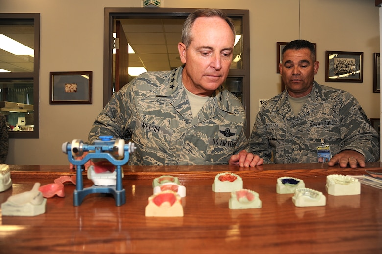 PETERSON AIR FORCE BASE, Colo. - Chief of Staff of the Air Force Gen. Mark A. Welsh III peers through a series of dental appliances as Master Sgt. Edward Salazar, 21st Medical Group dental lab non-commissioned officer in charge of removables, explains how these items are used to create products like retainers and night guards during his visit here June 18. The visit to Peterson's Area Dental Lab followed a base Airman's call, where Welsh thanked the Airmen of the 21st Space Wing and spoke about the importance of every Airman and in improving communication within the Air Force. (U.S. Air Force photo/Staff Sgt. J. Aaron Breeden)