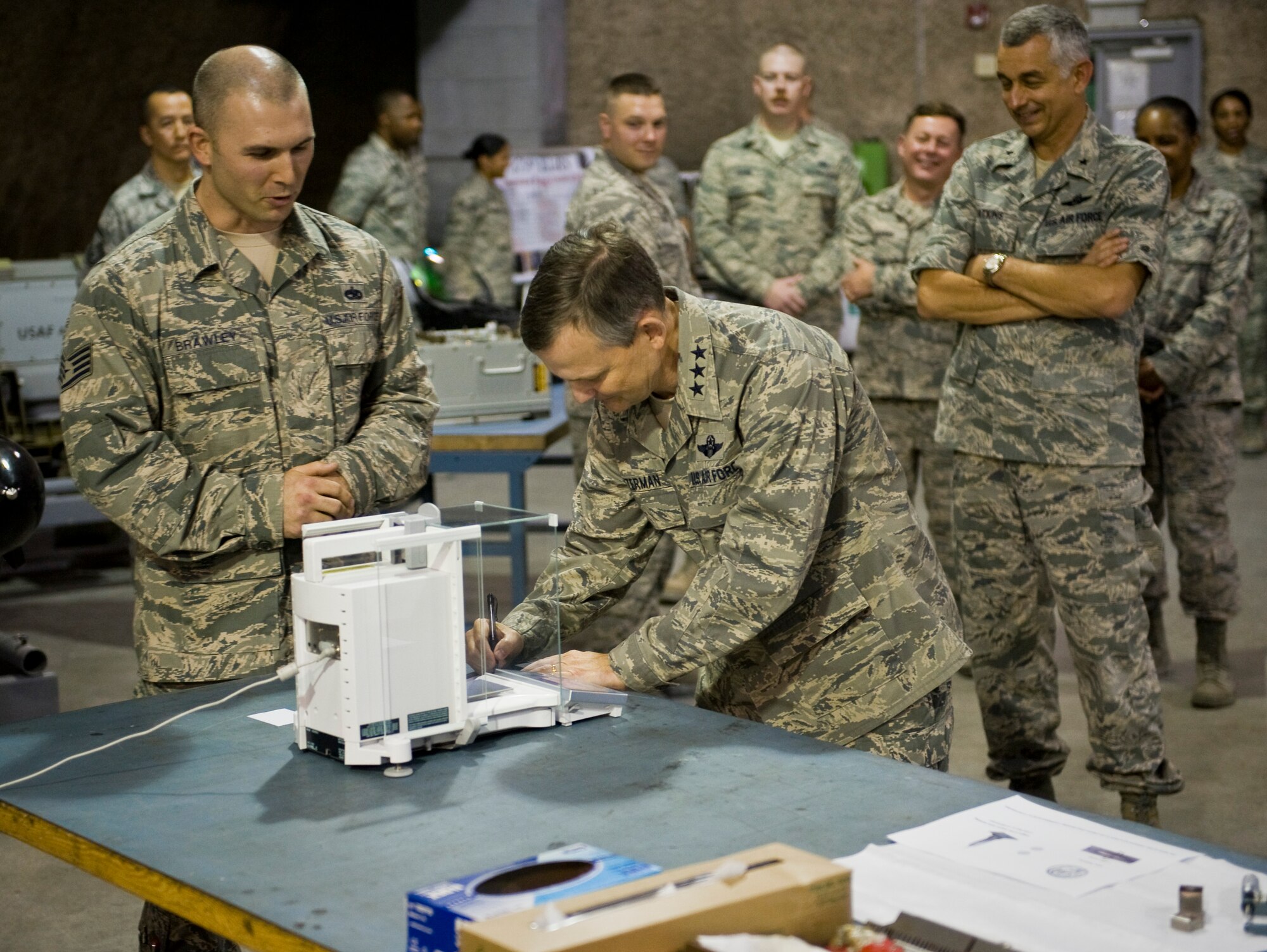 Staff Sgt. Brian Brawley shows Lt. Gen. John W. Hesterman III how his job and what he does supports the mission at the 379th Air Expeditionary Wing in Southwest Asia, July 23, 2013. Brawley is a 379th Expeditionary Maintenance Squadron precision measurement equipment laboratory craftsman deployed from Luke Air Force Base, Ariz. Hesterman is the Combined Force Air Component Commander responsible for developing contingency plans and conducting air operations in a 20-nation area of responsibility covering Central and Southwest Asia. (U.S. Air Force photo/Senior Airman Benjamin Stratton)