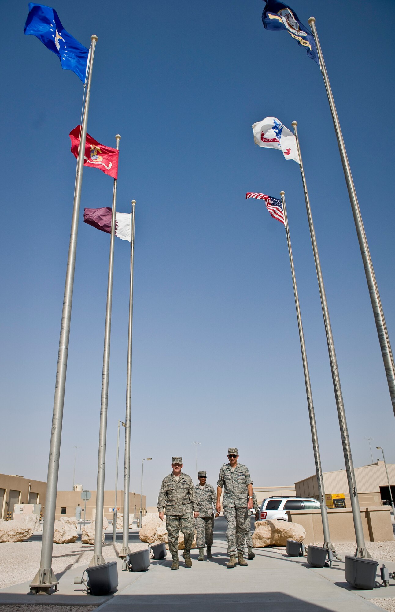 Lt. Gen. John W. Hesterman III walks with Brig. Gen. Roger H. Watkins and Chief Master Sgts. Shelina Frey and Rory Wicks as they enter the Wing Operations Center at the beginning of Hesterman?s tour at the 379th Air Expeditionary Wing in Southwest Asia, July 23, 2013. Hesterman is the Combined Force Air Component Commander, Watkins is the 379th AEW commander, Frey is the U.S. Air Forces Central Command command chief and Wicks is the 379th AEW command chief. (U.S. Air Force photo/Senior Airman Benjamin Stratton)