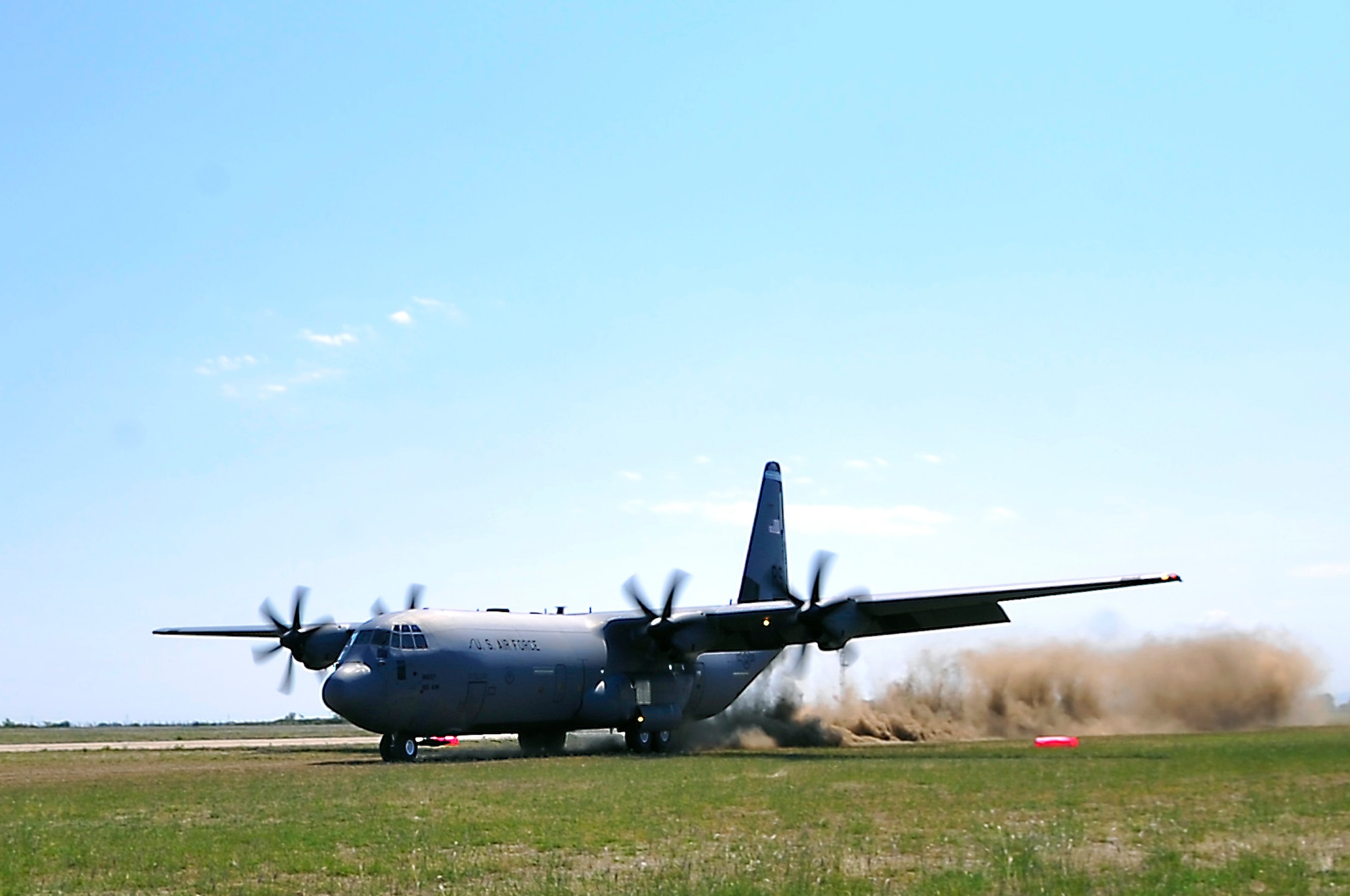 A C-130J Super Hercules performs a dirt-runway landing during a flying training deployment, July 15, 2013, Plovdiv, Bulgaria. FTD Thracian Summer was a two-week training deployment for American and Bulgarian forces to work together and learn how each other perform their mission. (U.S. Air Force photo/Airman 1st Class Trevor Rhynes)