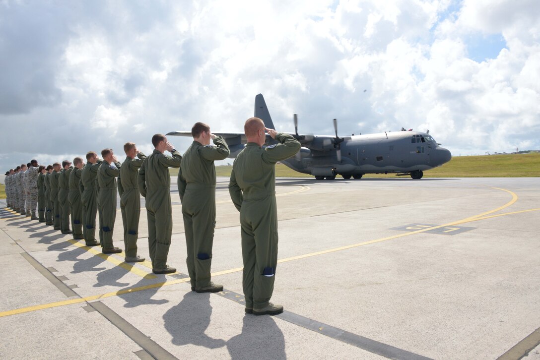 Members of the 17th Special Operations Squadron salute as the aircrew of MC-130P Combat Shadow 69-5825 completes a final taxi before the aircraft's departure from Kadena Air Base, Japan, July 17, 2013, to Davis-Monthan Air Force Base, Ariz.  The aircraft will retire after 44 years of active service and more than 18,000 flying hours.  (U.S. Air Force photo by Tech. Sgt. Kristine Dreyer/Released) 