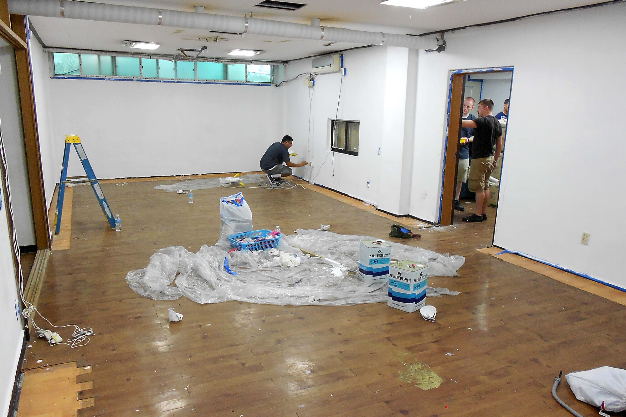Senior Airmen Herson Segovia and Timothy Rome, and Airman 1st Class Orion Briel, volunteers from the 55th Aircraft Maintenance Unit paint walls inside the Sungyook Orphanage in Pyongtaek, Republic of Korea, July 20. Thirty five volunteers from the 55th AMU visited the orphanage where they donated hundreds of toys, clothes, sports equipment and schools supplies. (U.S. Air Force photo/Airman 1st Class Blake Lewis)
