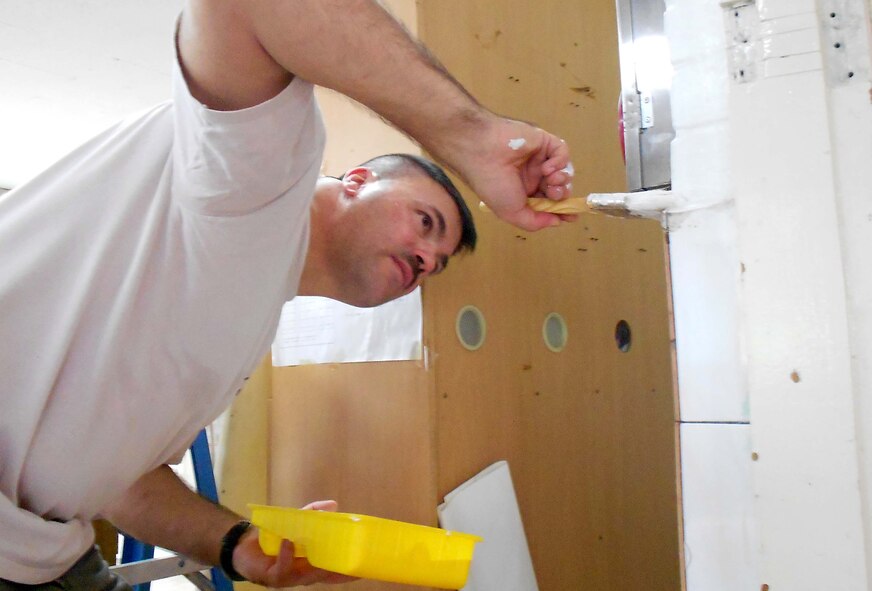 Senior Master Sgt. Kieth Edmonds, 55th Aircraft Maintenance Unit assistant superintendent, paints a wall inside the Sungyook Orphanage in Pyongtaek, Republic of Korea, July 20. Thirty five volunteers from the 55th AMU visited the orphanage where they donated hundreds of toys, clothes, sports equipment and schools supplies. (U.S. Air Force photo/Airman 1st Class Blake Lewis)