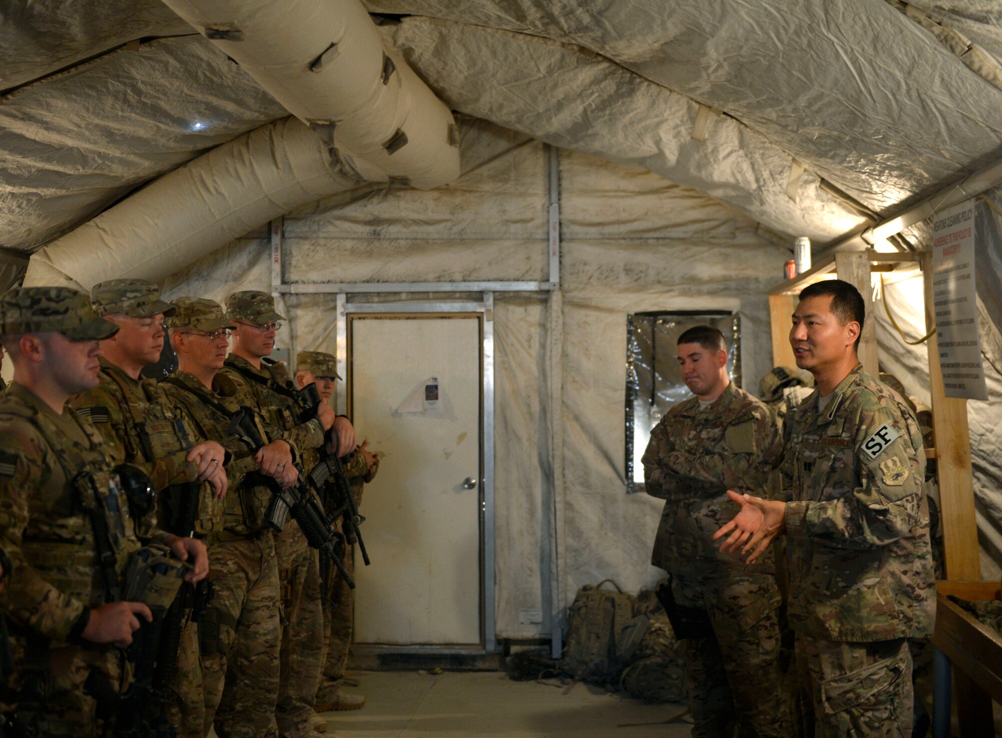 Chaplain (Capt.) Myung Cho and his assistant Staff Sgt. Frank Rivas, offer a devotion and worship service to airmen assigned to the 455th Expeditionary Security Forces Group prior to them going to work on Bagram Air Field, Afghanistan, July 21. Cho visits the Airmen as much as he can to raise their morale and offer a variety of worship services. ( U.S. Air Force photo/ Staff Sgt. Stephenie Wade)

