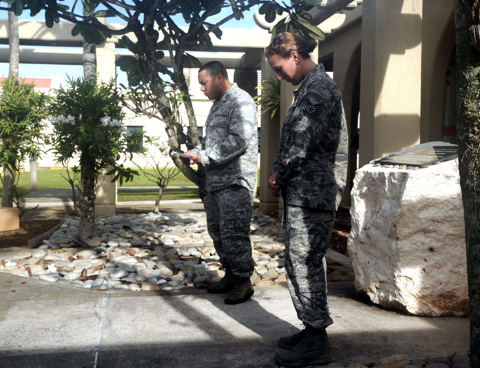 Tech. Sgt. Jaclyn Klimaski, 36th Medical Operations Squadron NCO in charge of flight and operations medicine, bows her head as Ch. (Capt.) Richard Rojas, 36th Wing, leads a prayer during a memorial for Lt. Col. George Martin, former  36th Medical Group deputy commander, at the clinic on Andersen Air Force Base, Guam, July 19, 2013. Airmen gathered to remember Martin and five other Airmen who lost their lives during a B-52 Stratofortress crash off the coast of Guam July 21, 2008. (U.S. Air Force photo by Airman 1st Class Mariah Haddenham/Released)