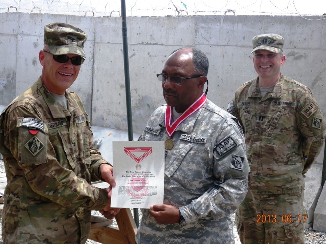 Colonel Richard Heitkamp, officer-in-charge of the Kabul Area Office, USACE Transatlantic District North presented James Myers, construction representative, with the Bronze Order of the de Fluery Medal during a ceremony at Forward Operating Base Gamberi, Afghanistan.