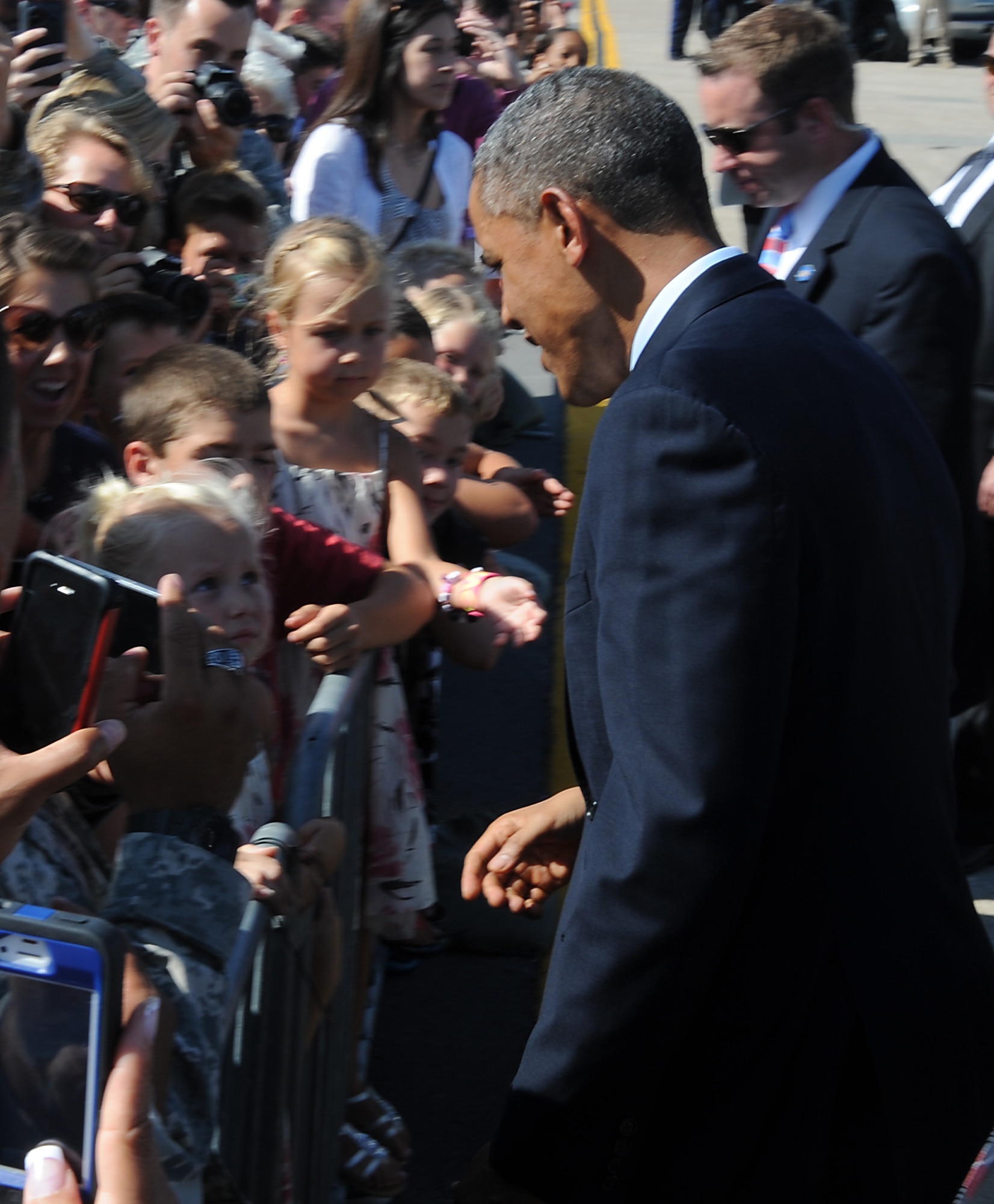 President Barack Obama is welcomed by a child after landing at Whiteman Air Force Base, Mo., July 24, 2013. The president landed at Whiteman en route to Warrensburg, Mo., for an official speech. (U.S. Air Force photo Airman 1st Class Bryan Crane/Released)
