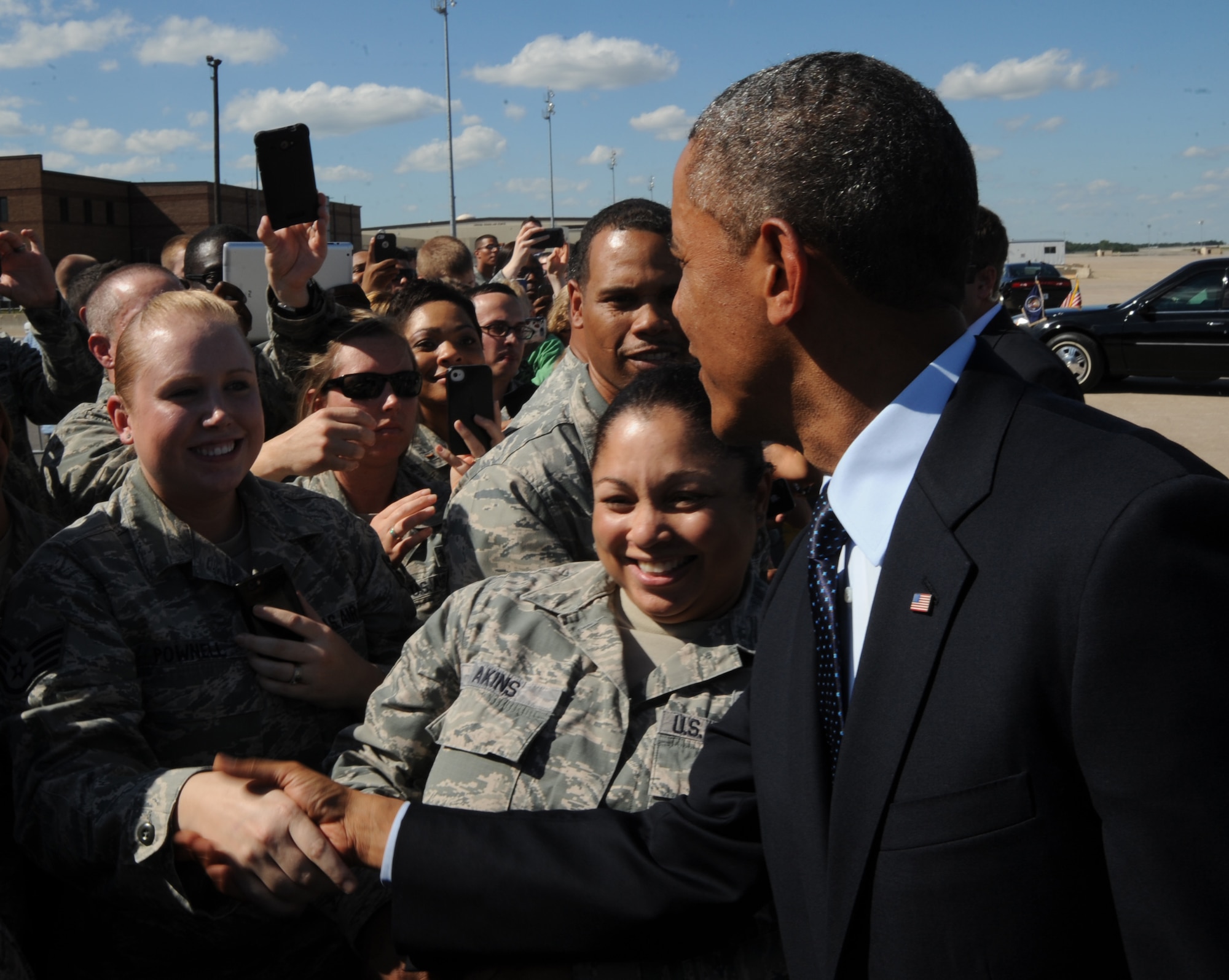 President Barack Obama shakes hands with Staff Sgt. Jessica Pownell, 509th Medical Operations Squadron NCO in charge of immunizations, after landing at Whiteman Air Force Base, Mo., July 24, 2013. The president landed at Whiteman en route to Warrensburg, Mo., for an official speech. (U.S. Air Force photo Airman 1st Class Bryan Crane/Released)