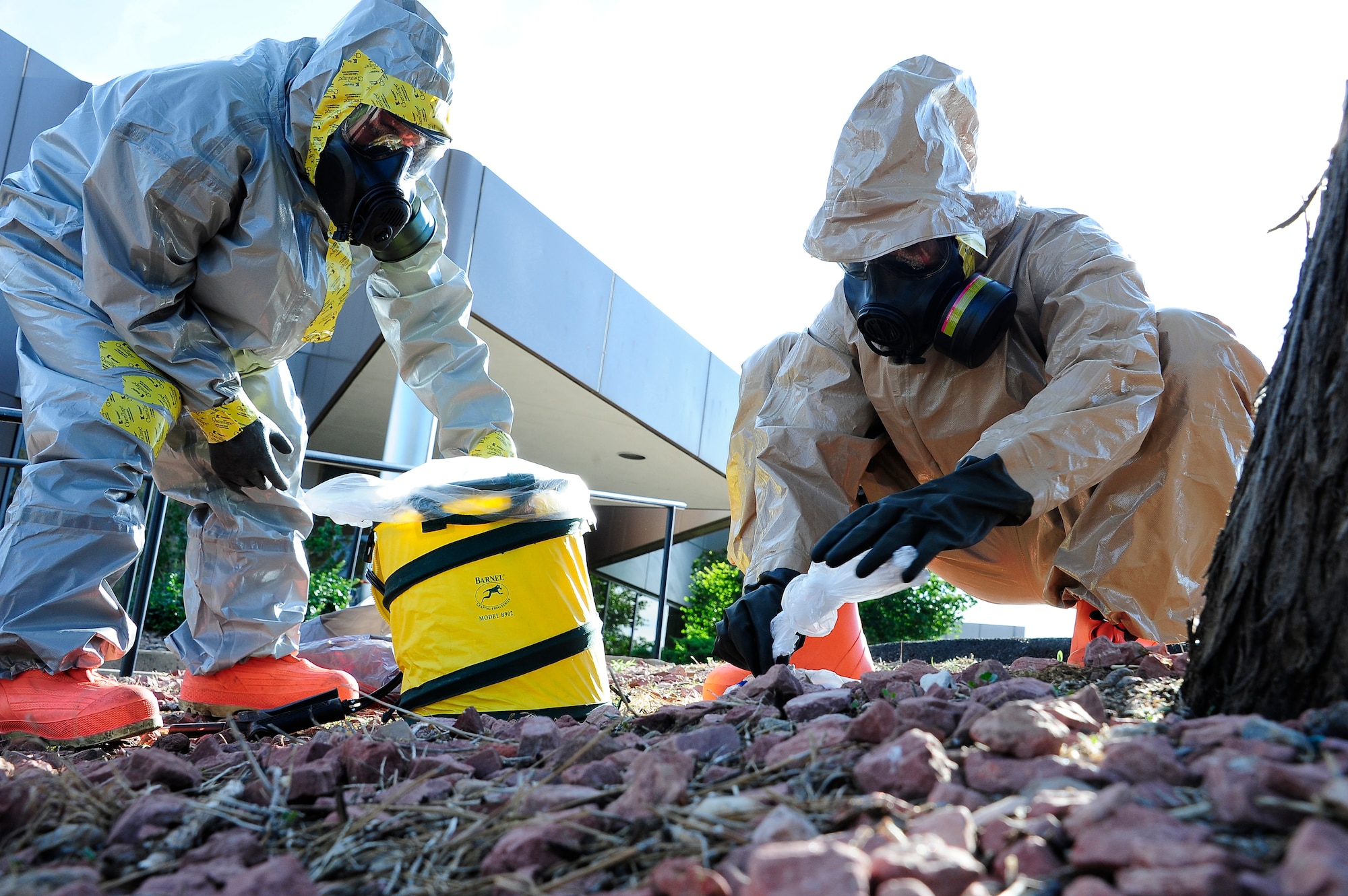 Colorado National Guardsmen Army Staff Sgt. Steve Russ and Sgt. Robert Chavez from the 8th Civil Support Team dispose hazardous material they found when they conducted a search and decontamination due to a notional F4 tornado that tore through the Bonfils Blood Center in Denver during the Vigilant Guard Exercise July 23. Vigilant Guard is an exercise focused on preparing for domestic emergencies and catastrophic events through interagency coordination.(U.S. Air National Guard photo by Staff Sgt. Nicole Manzanares)