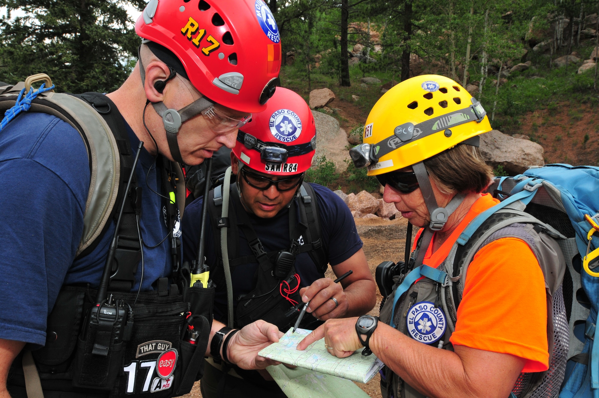 El Paso County Search and Rescue members Eric Babcock (left), Sam Saucedo, and Patty Baxter review a map during a simulated search and rescue mission at the U.S. Air Force Academy in Colo. Springs, Colo., during the Vigilant Guard exercise, July 22, 2013. The Vigilant Guard exercise is a weeklong exercise full of scenarios based on wildfires, tornadoes, air craft accidents, hazmat response, search and rescue, triage, medevac and other emergency-response measures. The training and experience gained from this exercise will provide the Colorado National Guard and supporting military units an opportunity to improve cooperation and operational relationships with their local, state, private sector, non-governmental organizations and federal partners. (U.S. Air National Guard photo by Tech. Sgt. Wolfram M. Stumpf)