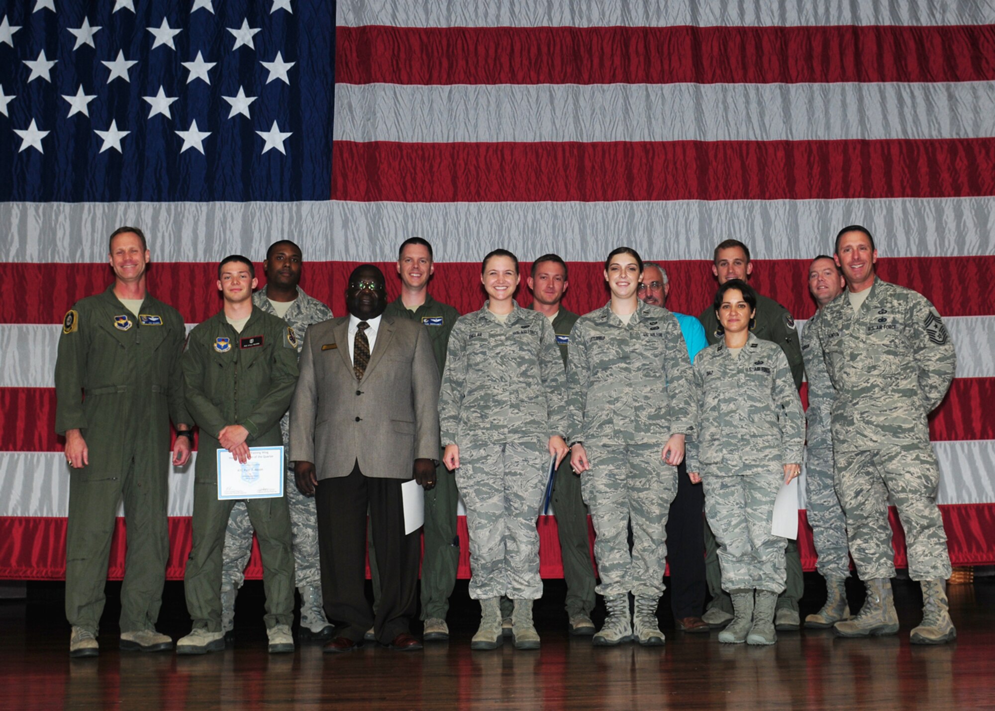 The 2013 second quarterly awards winners or their representatives pause for a photo on stage at Kaye Auditorium July 23. (U.S. Air Force Photo/Melissa Doublin)
