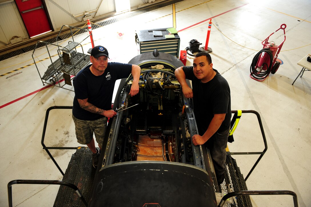 C.J. Gaecke (left) and Bryan Duran, Lockheed Martin structure mechanics, pose in front of the last U-2 of 22 to receive Cockpit Altitude Reduction Effort modifications on June 25, 2013 at Beale Air Force Base, Calif., to complete the project Lockheed Martin crews worked 10 hour shifts six days a week from September 2012 to June 2013. The upgrades virtually eliminate the risk of decompression sickness and hypoxia. (U.S. Air Force photo by Airman 1st Class Bobby Cummings/Released)