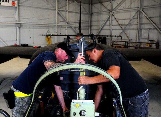 C.J. Gaecke (left) and Bryan Duran, Lockheed Martin structure mechanics, install the last piece of a U-2 aircraft modification on June 25, 2013 at Beale Air Force Base, Calif. The aircraft was one of 22 U-2 airframes to undergo Cockpit Altitude Reduction Effort modifications to enhance pilot safety. The upgrades virtually eliminate the risk of decompression sickness and hypoxia. (U.S. Air Force photo by Airman 1st Class Bobby Cummings/Released)